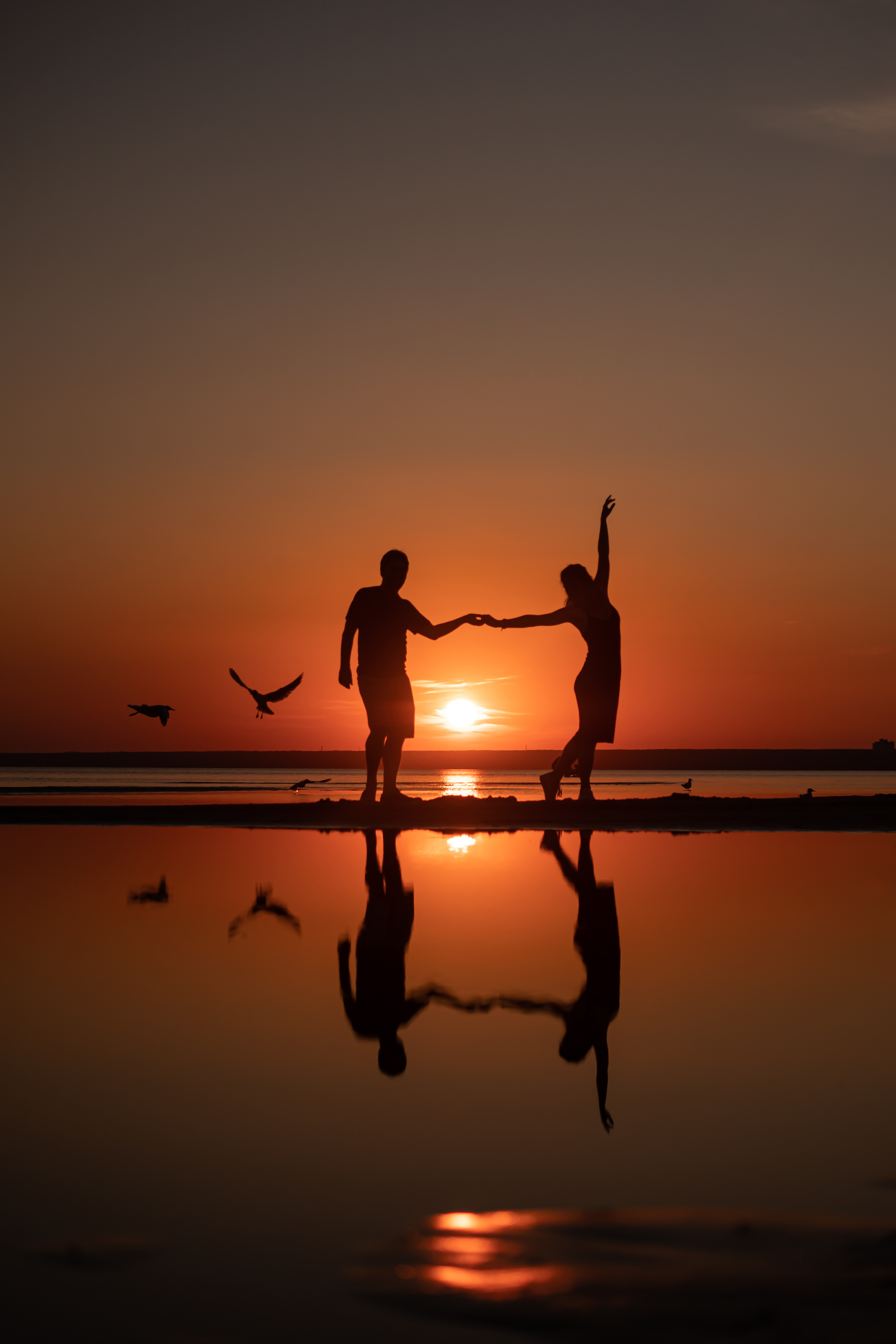 Silhouette of Couple Holding Hands